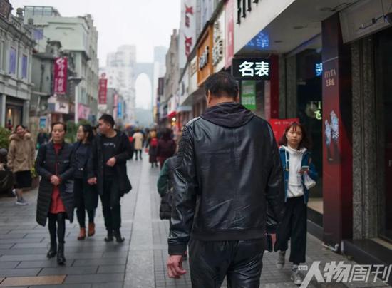 走在溫州市區最繁華的五馬街，經過這些年的“逃犯”生涯，金錦壽的背影顯得有些落寞